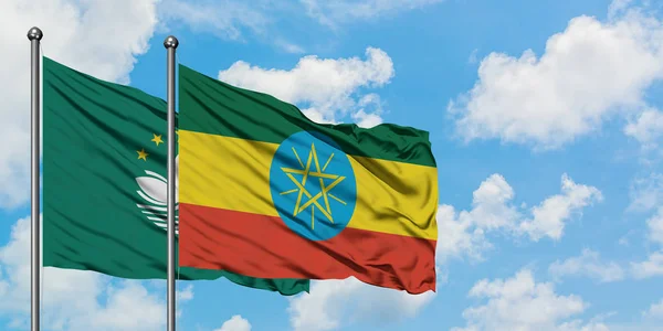 Macao and Ethiopia flag waving in the wind against white cloudy blue sky together. Diplomacy concept, international relations. — Stock Photo, Image