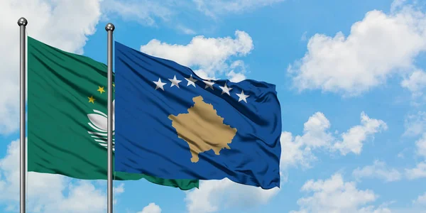 Macao and Kosovo flag waving in the wind against white cloudy blue sky together. Diplomacy concept, international relations.