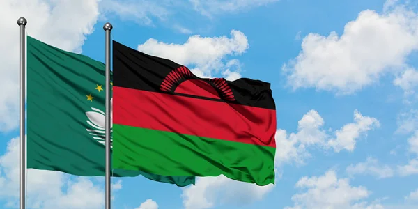 Macao and Malawi flag waving in the wind against white cloudy blue sky together. Diplomacy concept, international relations.