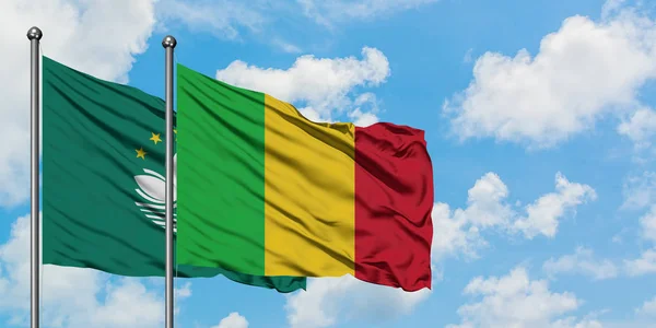 Macao and Mali flag waving in the wind against white cloudy blue sky together. Diplomacy concept, international relations.