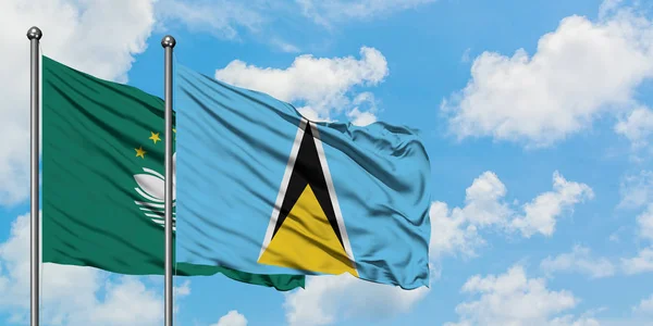 Macao and Saint Lucia flag waving in the wind against white cloudy blue sky together. Diplomacy concept, international relations.