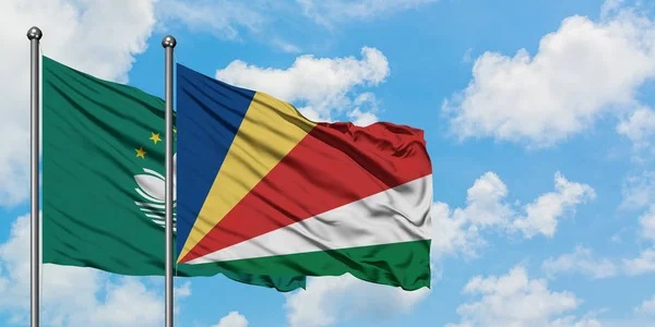 Macao and Seychelles flag waving in the wind against white cloudy blue sky together. Diplomacy concept, international relations. — Stock Photo, Image