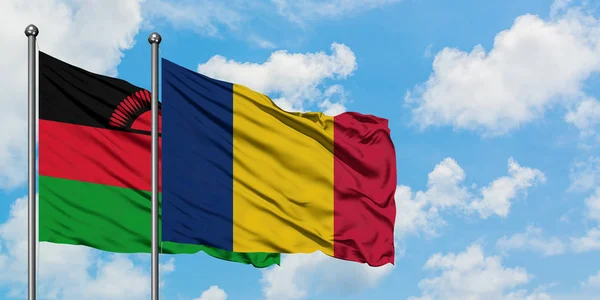 Malawi and Chad flag waving in the wind against white cloudy blue sky together. Diplomacy concept, international relations. — Stock Photo, Image