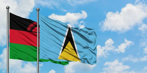 Malawi and Saint Lucia flag waving in the wind against white cloudy blue sky together. Diplomacy concept, international relations. — Stock Photo, Image