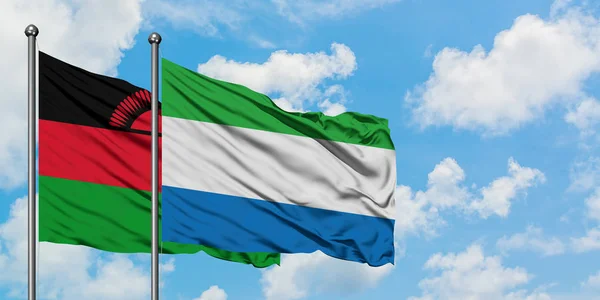 Malawi och Sierra Leone flagga vinka i vinden mot vit grumlig blå himmel tillsammans. Diplomatisk koncept, internationella relationer. — Stockfoto