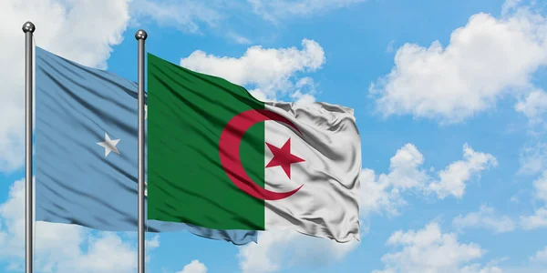 Micronesia and Algeria flag waving in the wind against white cloudy blue sky together. Diplomacy concept, international relations. — Stock Photo, Image
