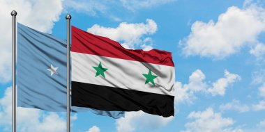 Mikronezya ve Suriye bayrağı birlikte beyaz bulutlu mavi gökyüzüne karşı rüzgarsal sallayarak. Diplomasi kavramı, uluslararası ilişkiler.