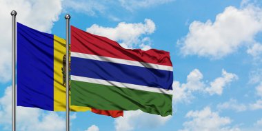 Moldova ve Gambiya bayrağı birlikte beyaz bulutlu mavi gökyüzüne karşı rüzgarda sallayarak. Diplomasi kavramı, uluslararası ilişkiler.