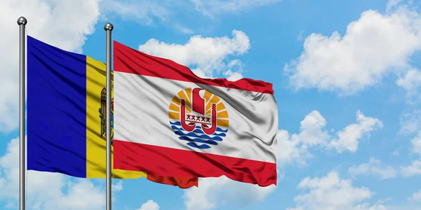 Moldova and French Polynesia flag waving in the wind against white cloudy blue sky together. Diplomacy concept, international relations. — Stock Photo, Image
