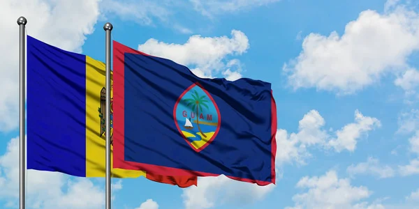 Moldova and Guam flag waving in the wind against white cloudy blue sky together. Diplomacy concept, international relations. — Stock Photo, Image