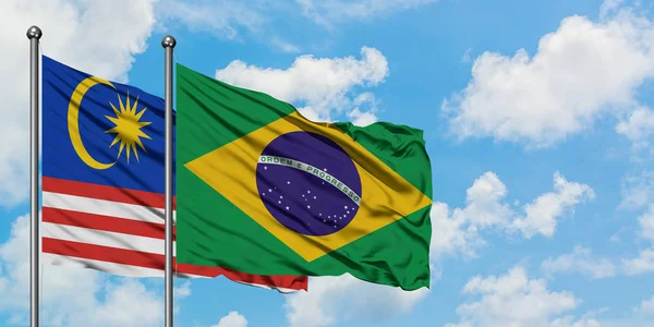 Malaysia and Brazil flag waving in the wind against white cloudy blue sky together. Diplomacy concept, international relations. — Stock Photo, Image