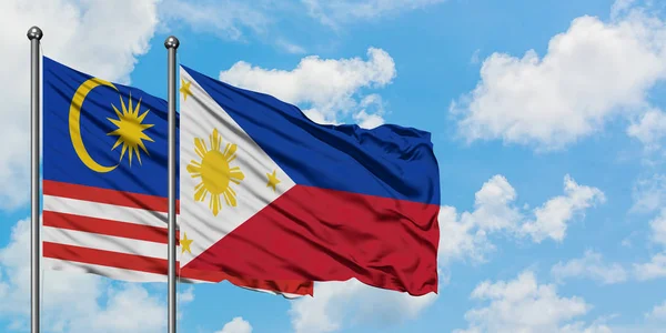 Флаг Малайзии и Филиппин, размахивающий ветром против белого облачного голубого неба. Концепция дипломатии, международные отношения . — стоковое фото