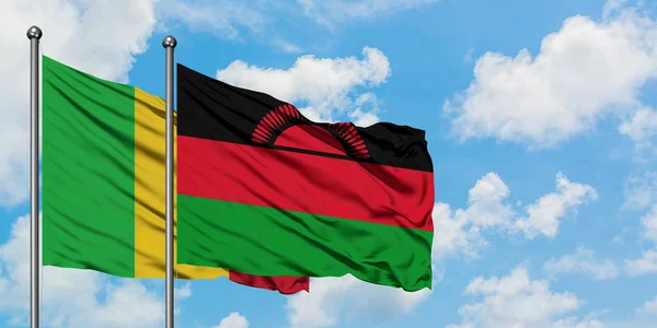 Mali and Malawi flag waving in the wind against white cloudy blue sky together. Diplomacy concept, international relations. — Stock Photo, Image