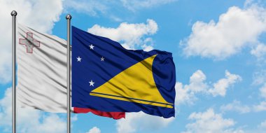 Malta ve Tokelau bayrağı birlikte beyaz bulutlu mavi gökyüzüne karşı rüzgarda sallayarak. Diplomasi kavramı, uluslararası ilişkiler.