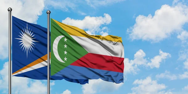 Marshall Islands and Comoros flag waving in the wind against white cloudy blue sky together. Diplomacy concept, international relations. — Stock Photo, Image