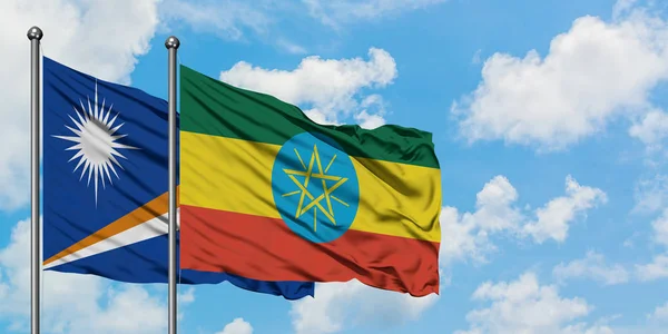 Marshall Islands and Ethiopia flag waving in the wind against white cloudy blue sky together. Diplomacy concept, international relations. — Stock Photo, Image