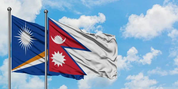 Marshall Adaları ve Nepal bayrağı birlikte beyaz bulutlu mavi gökyüzüne karşı rüzgarda sallayarak. Diplomasi kavramı, uluslararası ilişkiler. — Stok fotoğraf
