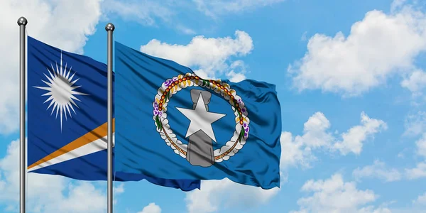 Marshall Islands and Northern Mariana Islands flag waving in the wind against white cloudy blue sky together. Diplomacy concept, international relations. — Stock Photo, Image