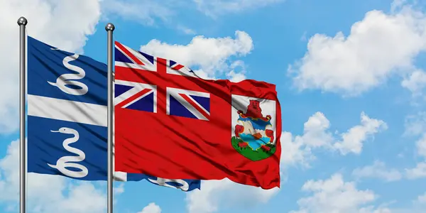 Bandera de Martinica y Bermudas ondeando en el viento contra el cielo azul nublado blanco juntos. Concepto diplomático, relaciones internacionales . —  Fotos de Stock