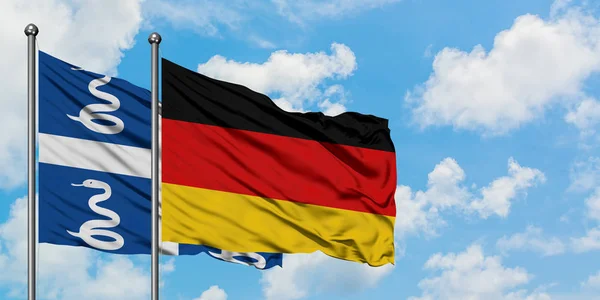 Martinique and Germany flag waving in the wind against white cloudy blue sky together. Diplomacy concept, international relations. — Stock Photo, Image