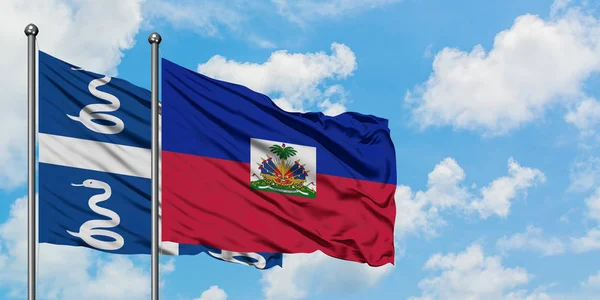Martinik ve Haiti bayrağı birlikte beyaz bulutlu mavi gökyüzüne karşı rüzgarda sallayarak. Diplomasi kavramı, uluslararası ilişkiler. — Stok fotoğraf