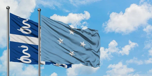 Martinique och Mikronesien sjunker vifta i vinden mot vit grumlig blå himmel tillsammans. Diplomatisk koncept, internationella relationer. — Stockfoto