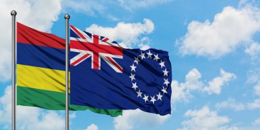 Mauritius ve Cook Adaları bayrağı birlikte beyaz bulutlu mavi gökyüzüne karşı rüzgarda sallayarak. Diplomasi kavramı, uluslararası ilişkiler.