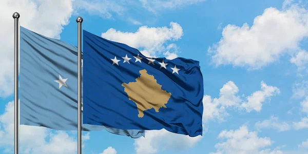 Micronesia and Kosovo flag waving in the wind against white cloudy blue sky together. Diplomacy concept, international relations. — 스톡 사진