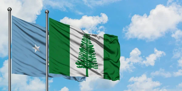 Micronesia and Norfolk Island flag waving in the wind against white cloudy blue sky together. Diplomacy concept, international relations. — Stock Photo, Image
