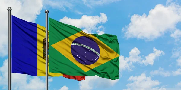 Bandera de Moldavia y Brasil ondeando en el viento contra el cielo azul nublado blanco juntos. Concepto diplomático, relaciones internacionales . — Foto de Stock