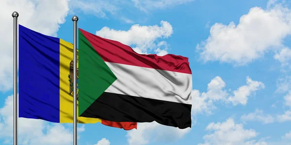 Moldova and Sudan flag waving in the wind against white cloudy blue sky together. Diplomacy concept, international relations. — Stock Photo, Image