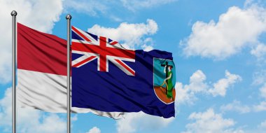 Monako ve Montserrat bayrağı birlikte beyaz bulutlu mavi gökyüzüne karşı rüzgarda sallayarak. Diplomasi kavramı, uluslararası ilişkiler.