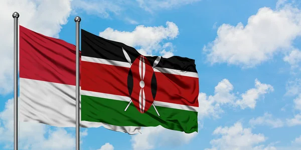 Monaco és Kenya zászló integetett a szél ellen, fehér felhős kék ég együtt. Diplomáciai koncepció, nemzetközi kapcsolatok. — Stock Fotó