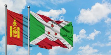 Moğolistan ve Burundi bayrağı birlikte beyaz bulutlu mavi gökyüzüne karşı rüzgarda sallayarak. Diplomasi kavramı, uluslararası ilişkiler.