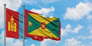 Moğolistan ve Grenada bayrağı birlikte beyaz bulutlu mavi gökyüzüne karşı rüzgarda sallayarak. Diplomasi kavramı, uluslararası ilişkiler.