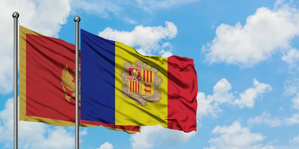 Bandera de Montenegro y Andorra ondeando en el viento contra el cielo azul nublado blanco juntos. Concepto diplomático, relaciones internacionales . — Foto de Stock