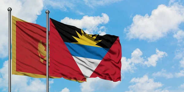 Karadağ ve Antigua ve Barbuda bayrağı birlikte beyaz bulutlu mavi gökyüzüne karşı rüzgarda sallayarak. Diplomasi kavramı, uluslararası ilişkiler. — Stok fotoğraf
