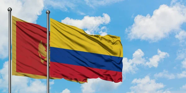 Η σημαία του Μαυροβουνίου και της Κολομβίας κουνώντας τον άνεμο ενάντια στον λευκό θολό γαλάζιο ουρανό μαζί. Φιλοσοφία της διπλωματίας, διεθνείς σχέσεις. — Φωτογραφία Αρχείου
