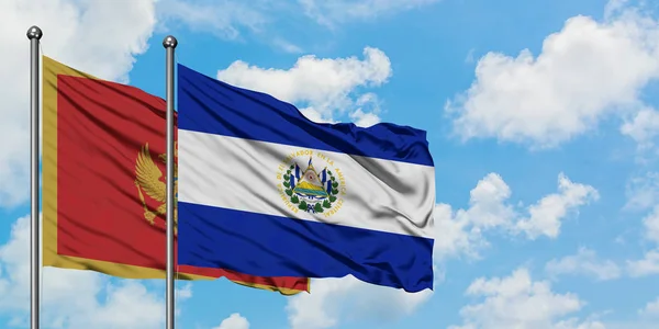 Bandera de Montenegro y El Salvador ondeando en el viento contra el cielo azul nublado blanco juntos. Concepto diplomático, relaciones internacionales . — Foto de Stock