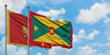 Karadağ ve Grenada bayrağı birlikte beyaz bulutlu mavi gökyüzüne karşı rüzgarda sallayarak. Diplomasi kavramı, uluslararası ilişkiler.