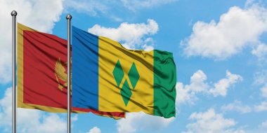 Karadağ ve Saint Vincent ve Grenadinler bayrak birlikte beyaz bulutlu mavi gökyüzüne karşı rüzgarda sallayarak. Diplomasi kavramı, uluslararası ilişkiler.