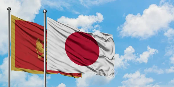 Montenegro dan Jepang mengibarkan bendera dalam angin melawan langit biru berawan putih bersama-sama. Konsep diplomasi, hubungan internasional . — Stok Foto