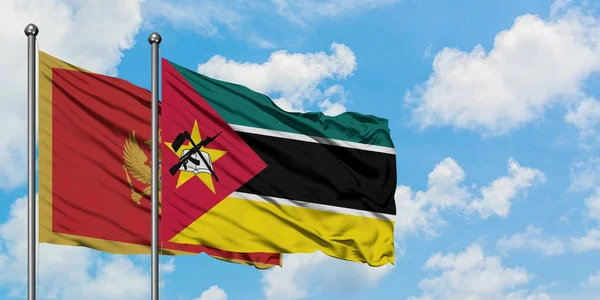 モンテネグロとモザンビークの旗は、一緒に白い曇り青い空に対して風に手を振る。外交概念、国際関係. — ストック写真