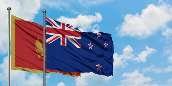 黑山和新西兰国旗在风中飘扬，白云蓝天相聚。外交概念、国际关系. — 图库照片