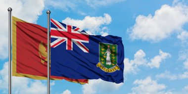 Karadağ ve İngiliz Virgin Adaları bayrağı birlikte beyaz bulutlu mavi gökyüzüne karşı rüzgarsal sallayarak. Diplomasi kavramı, uluslararası ilişkiler.