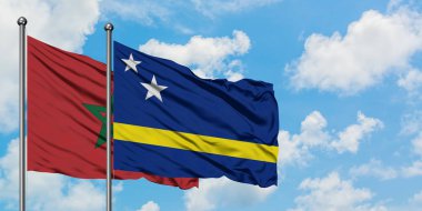 Fas ve Curacao bayrağı birlikte beyaz bulutlu mavi gökyüzüne karşı rüzgarda sallayarak. Diplomasi kavramı, uluslararası ilişkiler.