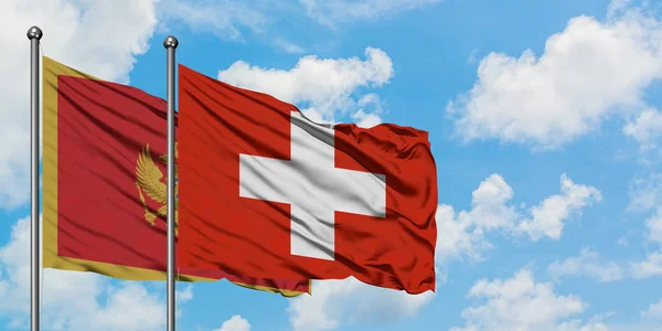 Флаг Черногории и Швейцарии вместе размахивает ветром против белого облачно-синего неба. Концепция дипломатии, международные отношения . — стоковое фото