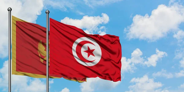 黑山和突尼斯国旗在风中飘扬，白云蓝天相聚。外交概念、国际关系. — 图库照片
