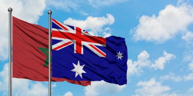 Fas ve Heard Adası ve Mcdonald Adaları bayrağı birlikte beyaz bulutlu mavi gökyüzüne karşı rüzgarda sallayarak. Diplomasi kavramı, uluslararası ilişkiler.