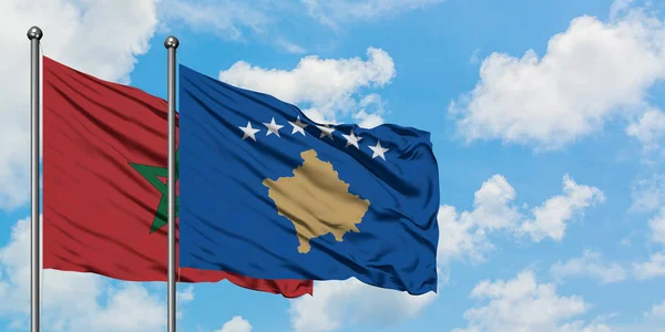 Drapeau du Maroc et du Kosovo agitant dans le vent contre le ciel bleu nuageux blanc ensemble. Concept de diplomatie, relations internationales . — Photo